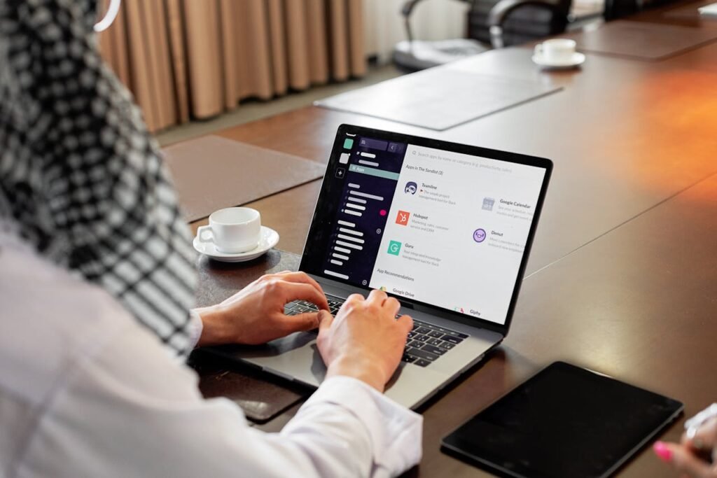 pexels-photo-8284729 Businessman using messaging app on laptop in modern office, engaging in team collaboration.